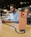 Phone standing upright on a desk while charging